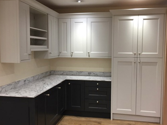Two-tone shaker kitchen with navy base units and grey wall cupboards
