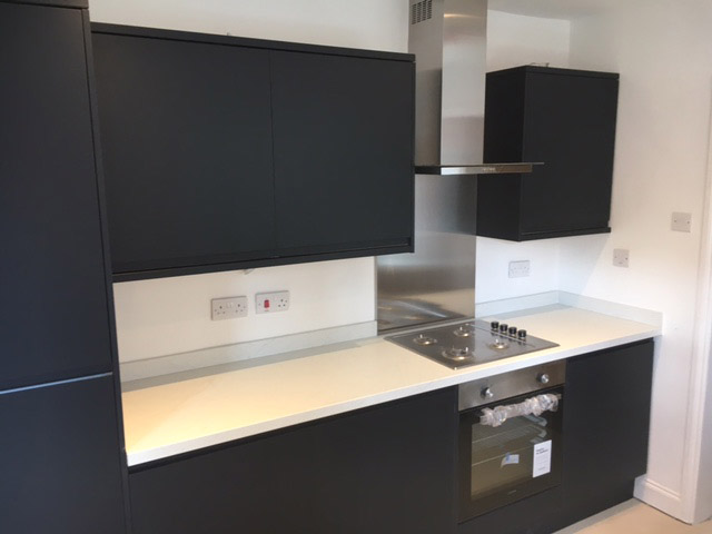 Matt charcoal kitchen with a stainless steel chimney hood