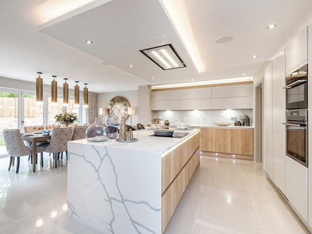 Open-plan kitchen with a waterfall island and pendant lights